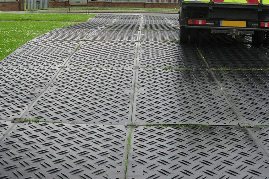 HDPE grass protection mats preventing tire ruts and ground damage from heavy vehicles
