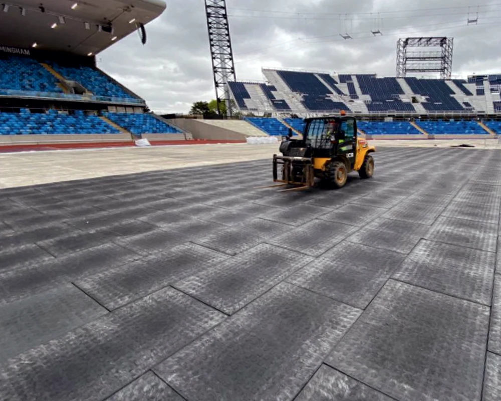 HDPE ground protection mats installed in US stadium for safe heavy equipment access and grass protection during event setup